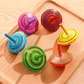 Multicolor wooden spinning tops, 4 cm, for toddlers and kids. Classic toy that boosts hand-eye coordination, concentration, and imaginative play. Safe and durable.