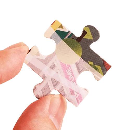Hand holding a puzzle piece with colorful design on a transparent background